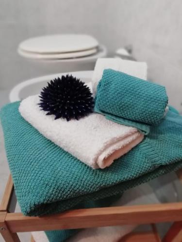 a pile of towels on a table with plates at Hotel Calabattaglia in Ventotene