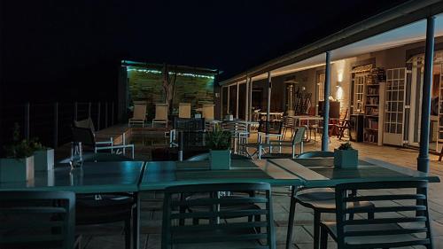 a green table and chairs on a patio at night at Rooiberg Wild Private Game Reserve in Ladismith