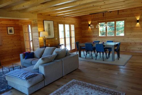 a living room with a couch and a table and chairs at Croix Noires FABULOUS & LUXURY chalet 11 pers by Alpvision Résidences in Vex