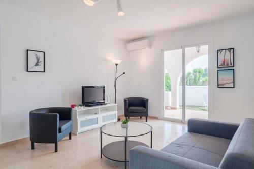 a living room with a couch and chairs and a tv at 049 - Modern & Spacious Holiday Villa With Private Pool in Fuengirola