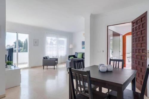 a dining room and living room with a table and chairs at 049 - Modern & Spacious Holiday Villa With Private Pool in Fuengirola