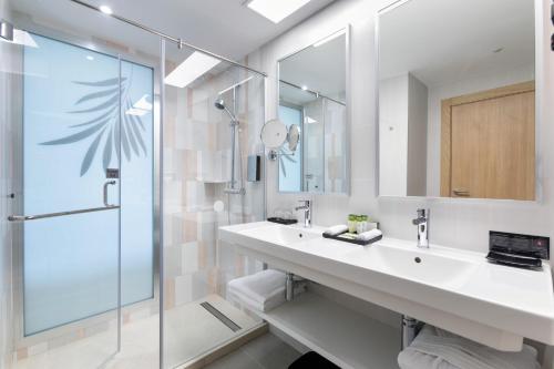 a bathroom with a sink and a shower at Hotel Riu Palace Palmeras - All Inclusive in Playa del Ingles