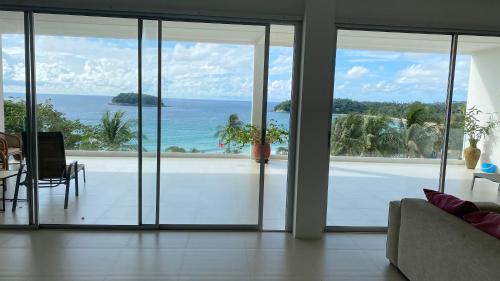 a living room with a view of the ocean at Kata Top Villas in Kata Beach