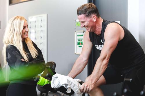 a man and a woman on a bike in a gym at Best Western ToRVEhallerne in Vejle