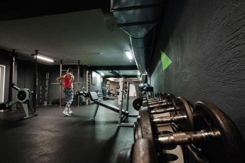 a man is standing in a gym with weights at Best Western ToRVEhallerne in Vejle