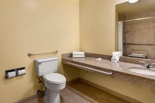 a bathroom with a toilet and a sink at Quality Inn Paradise Creek in Pullman