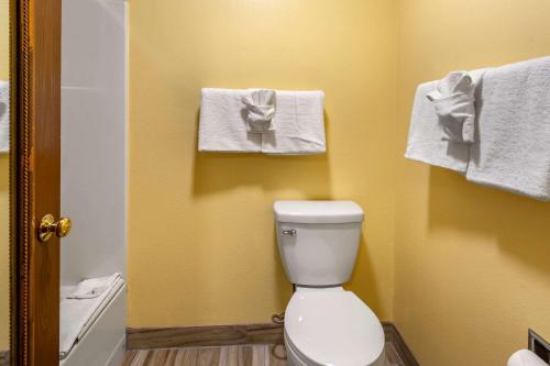 a bathroom with a white toilet and towels at Quality Inn Paradise Creek in Pullman
