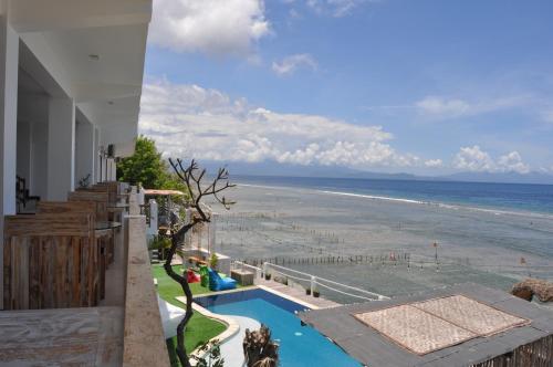 a view of the beach from the balcony of a house at Ocean Terrace Suite And Spa Luxury in Nusa Penida