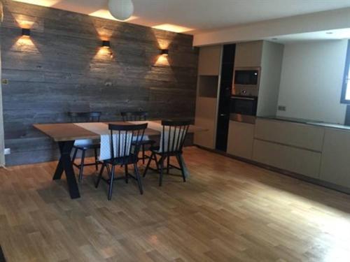 a kitchen with a table and chairs in a room at Maison d'hôtes Bastia in Bastia