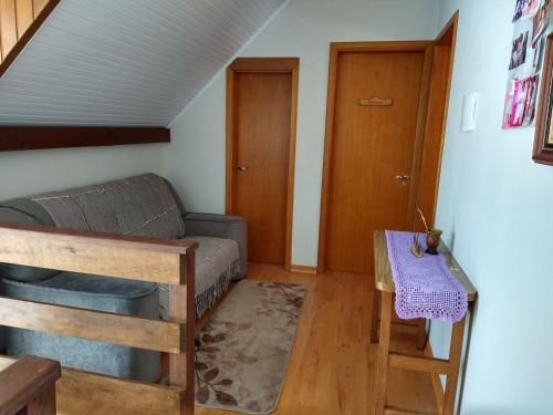 a living room with a couch and a table at Casa Compartilhada in Canela