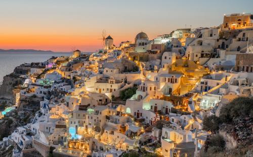 a view of the village of positano at sunset at Pezoules of Oia in Oia