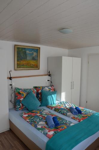 a bedroom with a large bed with colorful pillows at Gasthaus Löwen in Unterreichenbach