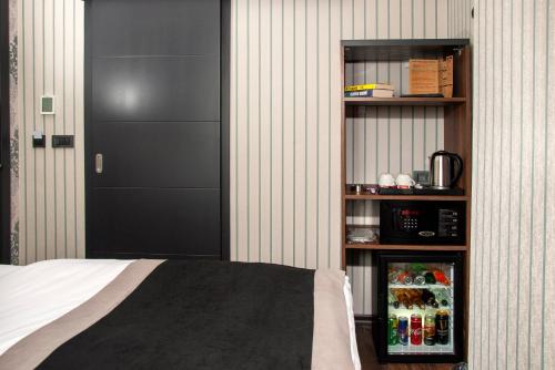 a bedroom with a bed and a black door at Hotel Bossuite Business in Istanbul