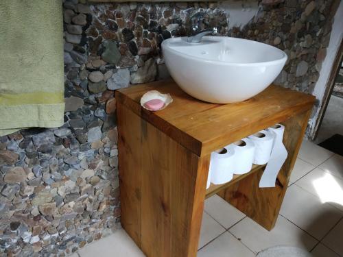 a bathroom with a white sink on a wooden table at Para pasar bien! in Maldonado
