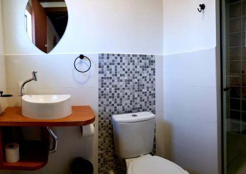 a bathroom with a sink and a toilet at Pousada Doce Mar in Guarda do Embaú