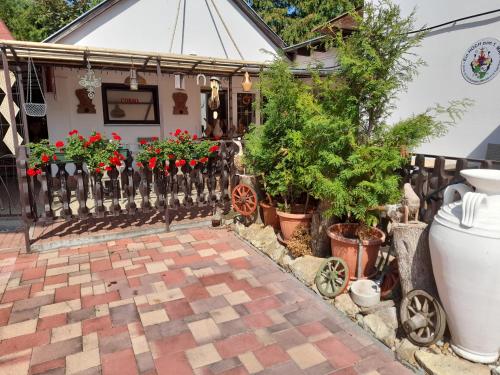 a house with flowers and a fence at Guest House Móritz in Keszthely