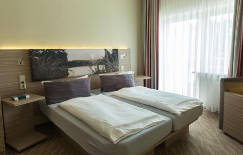 Ein Bett oder Betten in einem Zimmer der Unterkunft Hotel am Untersee