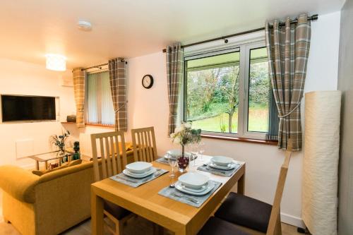 a dining room with a table and a chair at 1 Bedroom Newton Apartment l Free Parking l Wigan Royal Infirmary l Haigh Hall l Central Location in Wigan