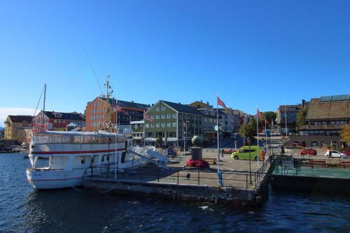 a boat is docked at a dock in a harbor at Kristiansund Apartments in Kristiansund