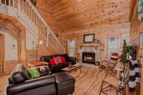 a living room with a couch and a fireplace at Highland Dream, Hot Tub, FREE tickets each paid day, Near Dollywood, WIFI!!! in Sevierville