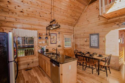 a kitchen and dining room in a log cabin at Highland Dream, Hot Tub, FREE tickets each paid day, Near Dollywood, WIFI!!! in Sevierville