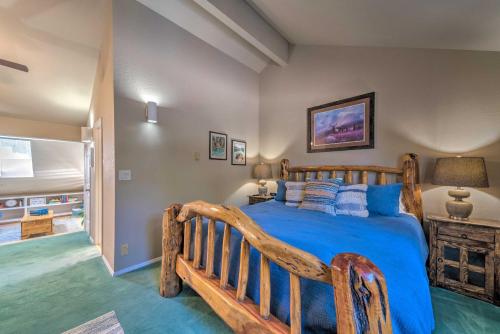 a bedroom with a wooden bed with blue pillows at Cloudcroft Townhome with Deck - 1 Mi to Burro Ave! in Cloudcroft