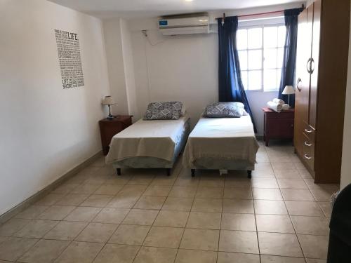 a room with two beds and a window at Belgrano 10 in Salta