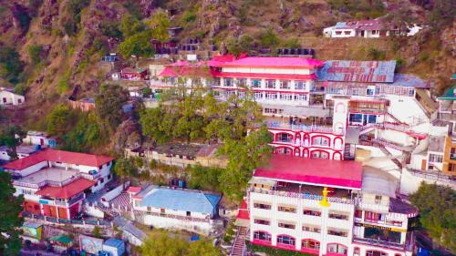 a group of buildings on top of a mountain at Calux Hill Queen at Mall Road with Parking - Formerly Amara in Mussoorie