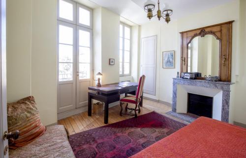 un salon avec une table et une cheminée dans l'établissement Centre historique, appartement climatisé avec terrasse, à Bordeaux