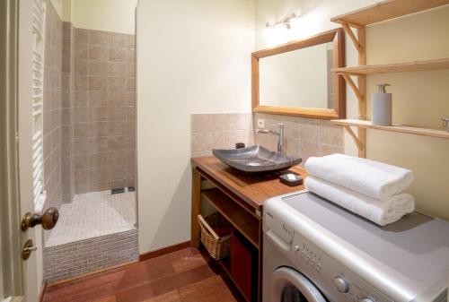 une salle de bain avec un lavabo et une machine à laver dans l'établissement Centre historique, appartement climatisé avec terrasse, à Bordeaux