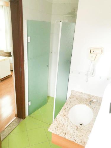 a bathroom with a sink and a shower at Millian Hotel in Jundiaí