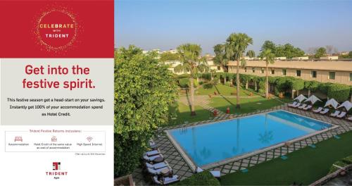 a hotel room with a swimming pool and a television at Trident Agra in Agra
