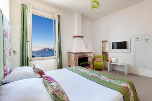 a bedroom with two beds and a fireplace at Il Sogno di Lina Sorrento Coast Capri View in Massa Lubrense