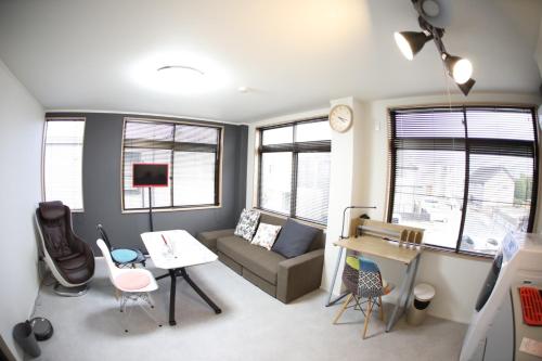 a living room with a couch and a table at Saitama Kyodo Building - Vacation STAY 02388v in Saitama
