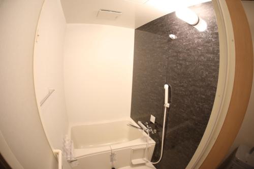 a bathroom with a shower and a sink and a mirror at Saitama Kyodo Building - Vacation STAY 02388v in Saitama