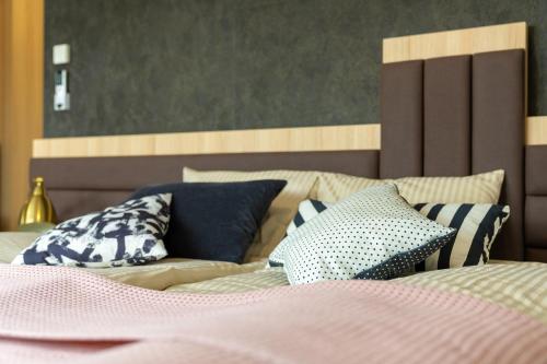 a bed with blue and white pillows on it at B&B La Siesta in Markovci