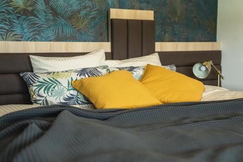 a bed with two yellow pillows on it at B&B La Siesta in Markovci