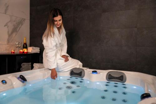 a woman in a bathtub in a room at B&B La Siesta in Markovci