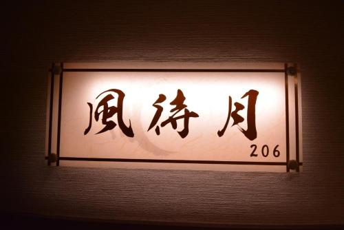 ein Schild an der Wand mit chinesischer Schrift darauf in der Unterkunft Daigo - Vacation STAY 08000v in Kanayama