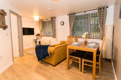 a living room with a couch and a table at Newton Apartment nr Wigan Hospital in Wigan