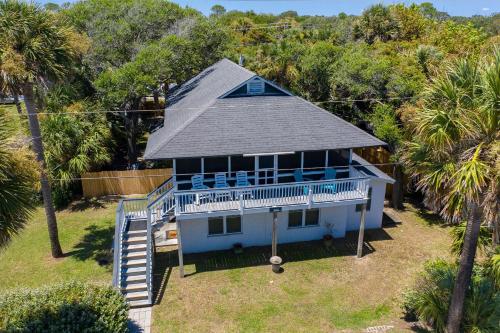 an aerial view of a blue house with palm trees at 306 E Arctic Ave. in Folly Beach