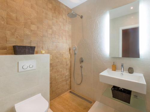 a bathroom with a shower and a toilet and a sink at The White House, Brac in Pučišća