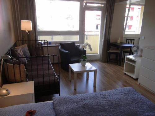 a living room with a couch and a table at City Lodging Apartments in Berlin