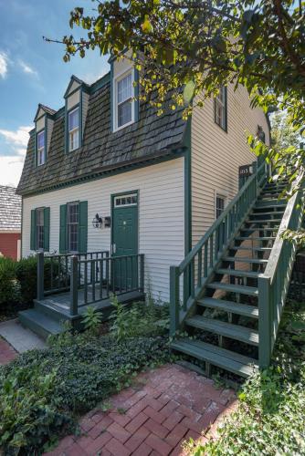 a house with a green door and stairs in front at Century Suites Hotel in Bloomington