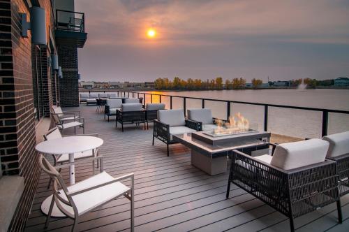 a deck with tables and chairs and a fire pit at Hyatt Place Sioux Falls South in Sioux Falls