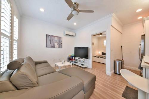 a living room with a couch and a flat screen tv at 1000#3 Renovated Home by Beach & Sand - AC & More! in Newport Beach
