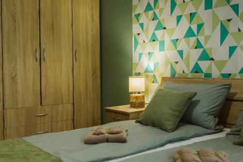 a bedroom with a bed with two teddy bears on it at Vively Lux Apartment - Central & Spacious with Balcony and free WiFi in Subotica
