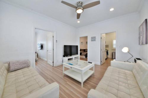 a living room with a couch and a tv at 1000#5 Premier Modern Home w View, Parking, and AC in Newport Beach