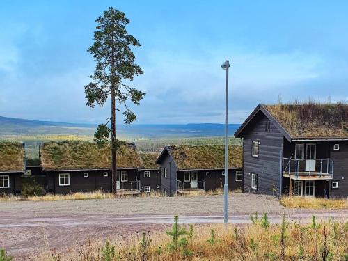 a group of black buildings with grass roofs at 8 person holiday home in S LEN in Sälen