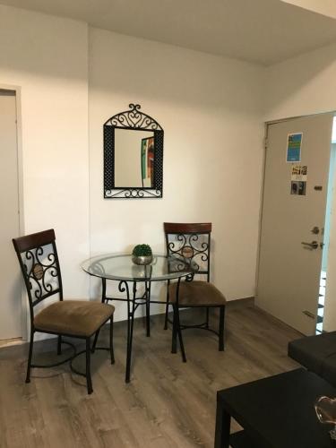 a dining room with a table and chairs and a mirror at 310Guest-House La Vida in San Juan